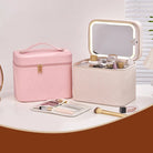 Pink and white cosmetic bags with makeup items on a table