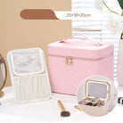 Pink makeup storage case with a mirror and brush on a light surface.