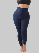 Navy blue leggings worn by a person on a white background